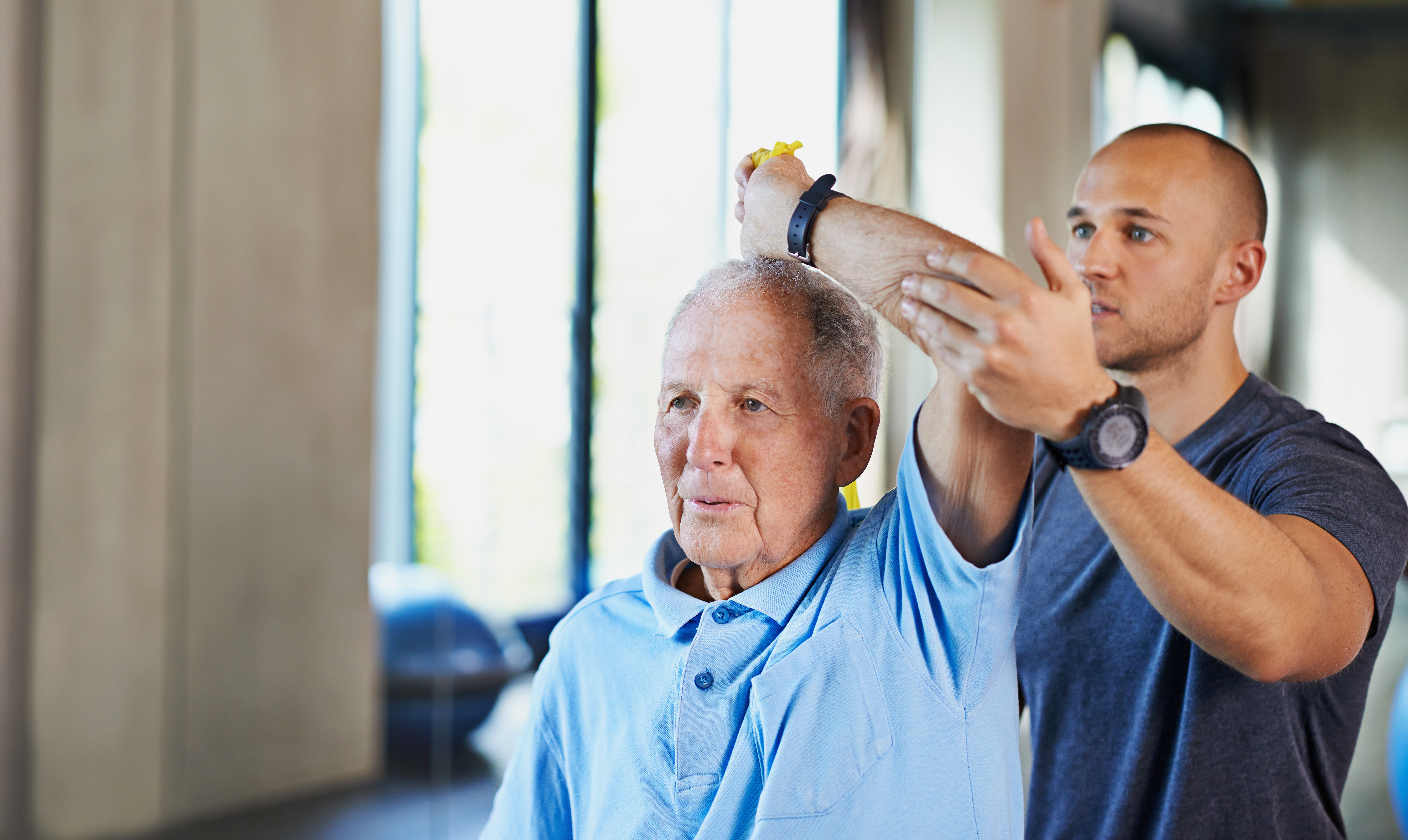 Physical therapist, helping and senior man with stretch, training and elderly support for care. Men, gym and exercise for health, wellness and coaching with arthritis for mature rehab and wellbeing Physical therapist, helping and senior man with stretch, training and elderly support for care. Men, gym and exercise for health, wellness and coaching with arthritis for mature rehab and wellbeing.
